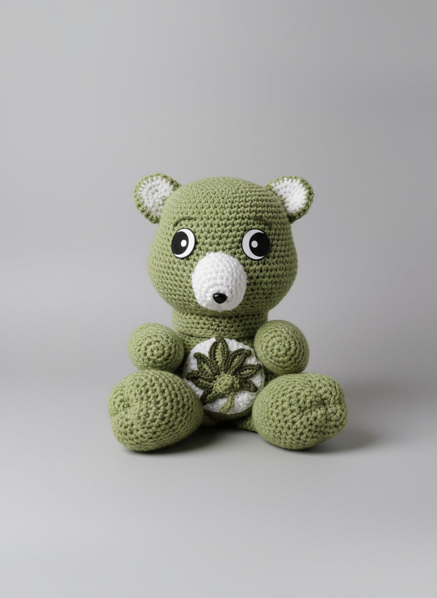 Green crochet toy with large eyes on a shelf with books and a pillow.
