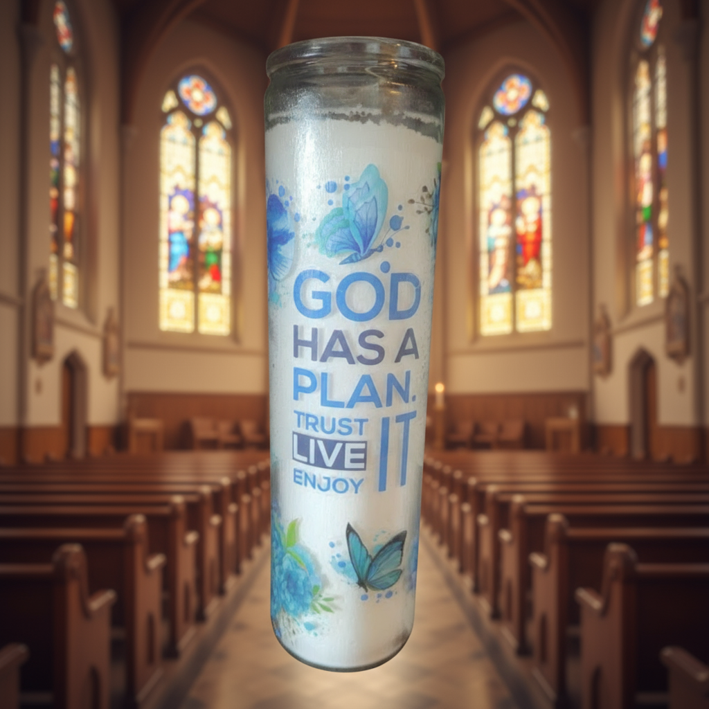 Candle with motivational text and butterfly designs against a brick wall background