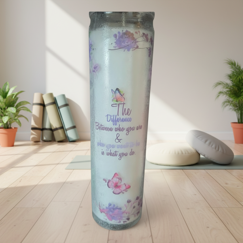 Decorative candle with text and designs against a brick wall